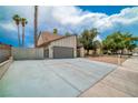 A large garage with a concrete driveway and block wall offers ample parking and curb appeal at 4431 El Campana Way, Las Vegas, NV 89121