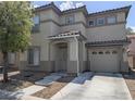 Inviting home exterior featuring a two-car garage, covered entrance, and neutral color palette at 4825 Shea Stadium Ave, Las Vegas, NV 89139