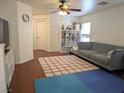 Cozy living room featuring a ceiling fan, a comfortable sofa, and shelving at 4825 Shea Stadium Ave, Las Vegas, NV 89139