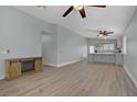 Bright and airy living room open to the kitchen, featuring modern floors and a decorative fireplace at 5129 Midnight Oil Dr, Las Vegas, NV 89122