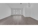 Spacious living room featuring natural light, window shutters, and sleek flooring at 5808 Spinnaker Reach Ave, Las Vegas, NV 89130