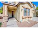 Inviting front entrance with stone accents, covered porch, and stylish exterior lighting at 8029 Flambeau St, Las Vegas, NV 89131
