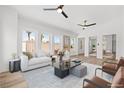 Bright and airy living room featuring stylish furniture, a ceiling fan, and large windows at 8032 Deep Stone Ave, Las Vegas, NV 89149