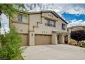 Handsome two-story home featuring an attached three-car garage with a long driveway at 8223 Saddleback Ledge Ave, Las Vegas, NV 89147