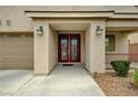 Inviting home entrance with double doors, manicured shrubbery and covered porch at 8223 Saddleback Ledge Ave, Las Vegas, NV 89147