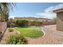 Landscaped backyard with green lawn and patio area, perfect for outdoor relaxation at 854 Santa Maria Way, Mesquite, NV 89027