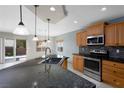 Kitchen featuring stainless steel appliances, a tile backsplash, and views of the backyard at 854 Santa Maria Way, Mesquite, NV 89027
