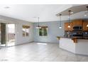 Open-concept living area with tile flooring, neutral paint, and ample natural light at 854 Santa Maria Way, Mesquite, NV 89027