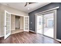 Spacious living room featuring French doors and a sliding door leading to a patio at 8560 Osmerea Ct, Las Vegas, NV 89149