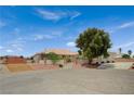 Single story home with a desert landscape, steps leading to the front, and a driveway leading to a garage at 9025 S Tenaya Way, Las Vegas, NV 89113
