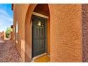 Inviting front entrance with a welcoming front door, decorative wreath, and neutral wall color at 9236 Keystone Ridge Ave, Las Vegas, NV 89148