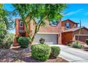 Charming two-story home featuring a well-maintained front yard, a driveway, and a two-car garage at 9236 Keystone Ridge Ave, Las Vegas, NV 89148