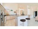 Modern kitchen boasts stainless steel appliances, granite countertops, and a center island with bar seating at 9622 Emeraude Ave, Las Vegas, NV 89147