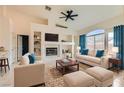 Bright living room features plush seating, fireplace, and a large arched window with natural light at 9622 Emeraude Ave, Las Vegas, NV 89147