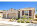 Charming single-story home with a three-car garage and attractive desert landscaping at 1129 Via Della Curia, Henderson, NV 89011
