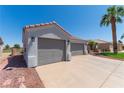 Attached two-car garage featuring neutral-colored doors and exterior lighting at 1195 Golf Club Dr, Laughlin, NV 89029