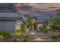 Stunning modern home with desert landscaping, rock ground cover, and a walkway to the front door at 1337 Villa Barolo Ave, Henderson, NV 89052