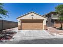 The property features a one-car garage with neutral trim, a spacious driveway, and desert landscaping, with a neighboring two-story house at 1905 Eskam St, Las Vegas, NV 89156