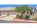 Home exterior with a two-car garage, desert landscaping, tile roof, and a communal mailbox at 201 Teller St, Henderson, NV 89074