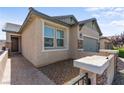 Close-up of a home's facade, showing the door, windows, and landscaping at 2207 Valdina St, Henderson, NV 89044