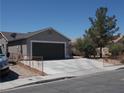 Single-story home featuring desert landscaping, and a spacious two-car garage at 2211 Chipplegate Way, North Las Vegas, NV 89032