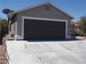 Exterior view of home with a two-car garage, and wide driveway at 2211 Chipplegate Way, North Las Vegas, NV 89032