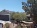 Exterior view of home with desert landscaping, and a spacious two-car garage at 2211 Chipplegate Way, North Las Vegas, NV 89032