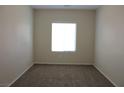 Neutral carpeted bedroom with a large window offering plenty of natural light at 2212 Sawtooth Mountain Dr, Henderson, NV 89044
