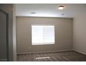 Bright, carpeted bedroom with recessed lighting and a large window for natural light at 2212 Sawtooth Mountain Dr, Henderson, NV 89044