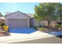 Inviting single-story home with manicured landscaping, spacious driveway, and a two-car garage at 2212 Sawtooth Mountain Dr, Henderson, NV 89044