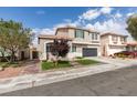 Inviting two-story home with a two-car garage, neat landscaping, and a brick-lined walkway at 2418 Brockton Way, Henderson, NV 89074