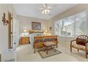Bright bedroom with large window, wooden bed frame, and comfortable seating area at 2537 Nashira St, Henderson, NV 89044