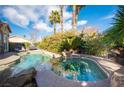 Inviting pool and spa area with lush landscaping, providing a private and relaxing outdoor retreat at 340 Autumn Palace Ct, Las Vegas, NV 89144
