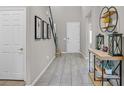 Inviting entryway with tile floors, neutral walls, and decorative console table and decor at 404 Lost Horizon Ave, Henderson, NV 89002