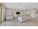Spacious living room showcasing neutral colors, modern tile floors, and comfortable seating arrangements at 404 Lost Horizon Ave, Henderson, NV 89002