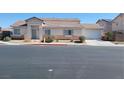 Charming single-story home featuring a well-kept front yard and attached two car garage at 4718 Victoria Garden Ave, North Las Vegas, NV 89031