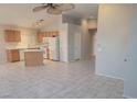 Open-concept kitchen featuring an island and white appliances overlooking the living area at 4718 Victoria Garden Ave, North Las Vegas, NV 89031