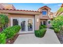 Inviting single-story home with lush landscaping and a red tile roof, offering curb appeal at 5008 Shoal Creek Cir, Las Vegas, NV 89113