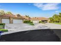 Charming home with a red tile roof, three-car garage and a well-manicured front yard at 5008 Shoal Creek Cir, Las Vegas, NV 89113