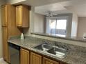 Well-appointed kitchen featuring granite countertops, stainless steel sink and ample cabinet space at 5055 W Hacienda Ave # 2102, Las Vegas, NV 89118