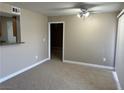 Inviting living room with neutral walls, carpeted floor and a view through to the kitchen at 5055 W Hacienda Ave # 2102, Las Vegas, NV 89118