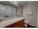 Cozy bathroom with wood cabinets, great lighting, and a neutral color palette at 573 Sellers Pl, Henderson, NV 89011