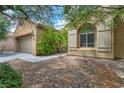 Well-maintained exterior showcasing a neat landscape and a two-car garage, blending curb appeal with functionality at 5992 Quintillion Ave, Las Vegas, NV 89122