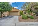 Charming single-story home featuring a well-manicured front yard and an attached two-car garage at 5992 Quintillion Ave, Las Vegas, NV 89122