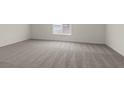 Spacious bedroom with plush carpet and a large window that provides natural light at 6197 Blood Lily Ave, Las Vegas, NV 89122