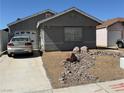 Single-story home with a single car garage and a desert rock garden in the front yard at 6766 Sebring St, Las Vegas, NV 89103