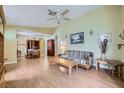 Bright and airy living room with a ceiling fan, wood-look flooring, and neutral paint at 6766 Sebring St, Las Vegas, NV 89103