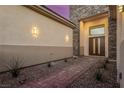 Inviting front entrance with a stone pathway and a modern double door design at 7062 Maverick St, Las Vegas, NV 89131