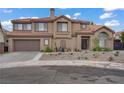Charming two-story home with a well-manicured front yard and a two-car garage at 7621 Hackensack Ct, Las Vegas, NV 89128