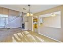 Open concept living area featuring a cozy fireplace, tile floors and staircase at 8231 Burnt Sienna St, Las Vegas, NV 89123